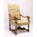 AN 18TH CENTURY FRENCH OAK ARMCHAIR, with needlework back and seat and carved legs.