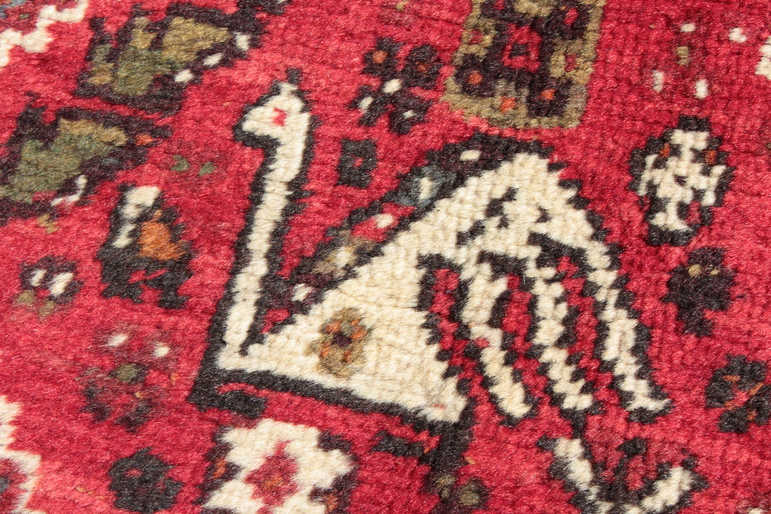 A PERSIAN TRIBAL SHIRAZ QASHQAI CARPET with a large motif on a red ground. 11ft 6ins x 5ft 6ins. - Image 2 of 8