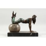 A BRONZE MODEL OF A GIRL, exercising with a large ball, on a marble base. 10ins long.
