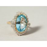 A 9CT GOLD LARGE BLUE TOPAZ AND DIAMOND RING.