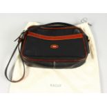 A BLACK AND TAN BALLY BAG, in a Bally dust bag.