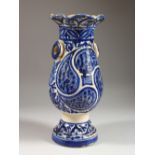 AN ISLAMIC BALUSTER SHAPED POTTERY VASE, with stylised blue glazed decoration. 13.5ins high.