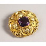 A VICTORIAN GOLD AND AMETHYST BROOCH.