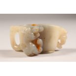 A SMALL CARVED WHITE JADE LIBATION CUP. 3.25ins wide.