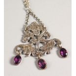 AN ART NOUVEAU SILVER AND AMETHYST PENDANT AND CHAIN, with a female head amongst a foliate mount,