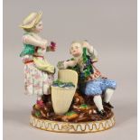 A GOOD MEISSEN GROUP OF A YOUNG BOY AND GIRL with hopper and fruiting vines. Cross swords mark in