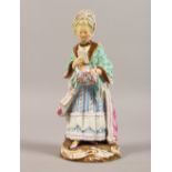 A GOOD MEISSEN FIGURE OF A LADY, standing reading a book. Cross swords mark in blue. Incised D66.