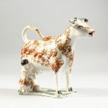 A STAFFORDSHIRE MOTTLED BROWN COW CREAMER with milkmaid. 6.5ins long.