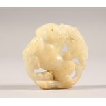 A CARVED WHITE JADE ROUNDEL. 2ins diameter.