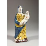 A 19TH CENTURY CONTINENTAL FAIENCE POTTERY MODEL OF A MADONNA AND CHILD. 8.5ins high.