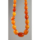 AN AMBER NECKLACE. 2ft 2ins long. 39gms.