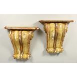A PAIR OF 19TH/20TH CENTURY CARVED, GESSO AND PAINTED SCROLLING WALL BRACKETS. 41cms high x 40cms