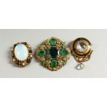 A VICTORIAN OVAL MOONSTONE BROOCH and TWO OTHER BROOCHES.
