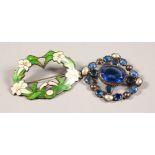 A STERLING SILVER AND ENAMEL BROOCH and A BLUE STONE & MOTHER-OF-PEARL BROOCH.