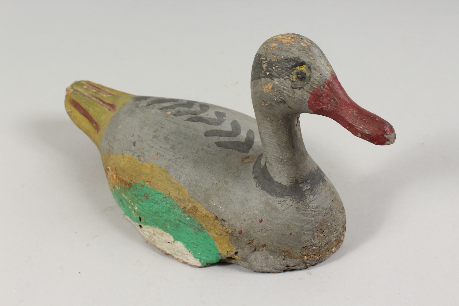 A CARVED AND PAINTED DUCK DECOY. 11ins long. - Image 2 of 2