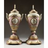 A LARGE PAIR OF TWO-HANDLED URN SHAPED BERLIN VASES, as lamps, with classical panel, on a wooden