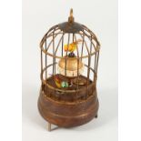 A SMALL AUTOMATON BIRD CAGE CLOCK. 7ins high.