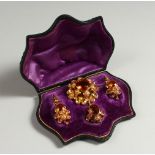 A VICTORIAN GOLD AND TOPAZ SUITE, PENDANT AND EARRINGS in a fitted leather case.