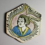 A PERSIAN GLAZED POTTERY HEXAGONAL SHAPED TILE, painted with a female bust. 7.5ins wide.