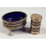 AN OVAL PIERCED SALT CELLAR with sapphire blue liner, London 1942, and A PEPPERETTE, London 1907 (