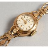 A LADIES' 9CT GOLD ACCURIST WRISTWATCH AND BRACELET. 11 grams including works.
