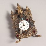 A MINIATURE CONTINENTAL SILVER CLOCK, with white enamel dial, figures and semi-precious stones. 4ins