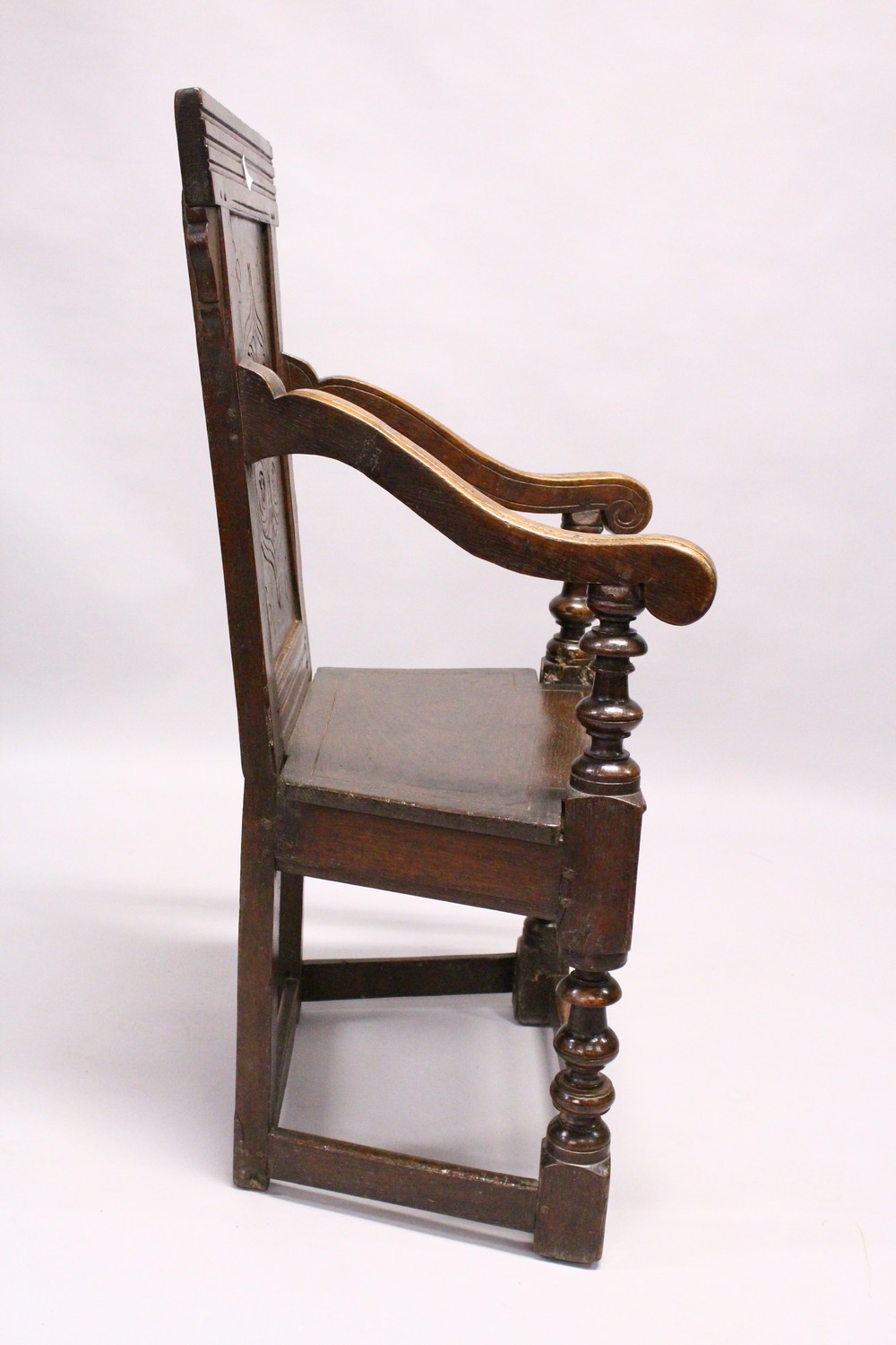 AN 18TH CENTURY OAK WAINSCOT ARMCHAIR, with carved back, solid seat and curving arms and turned - Image 9 of 11