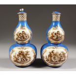 A PAIR OF DRESDEN AUGUSTUS REX DOUBLE BLUE VASES AND COVERS, with panels of cupids. AR mark. 7ins