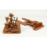 A GOOD PAIR OF BLACK FOREST CARVED WALNUT ADJUSTABLE BOOK RESTS, carved with goats. Each 10.75ins