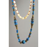 A MOTHER-OF-PEARL NECKLACE and AN ISLAMIC NECKLACE (2).