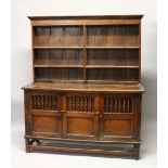 AN 18TH CENTURY OAK DRESSER, with a double Delft rack, the base with three cupboard doors, each part