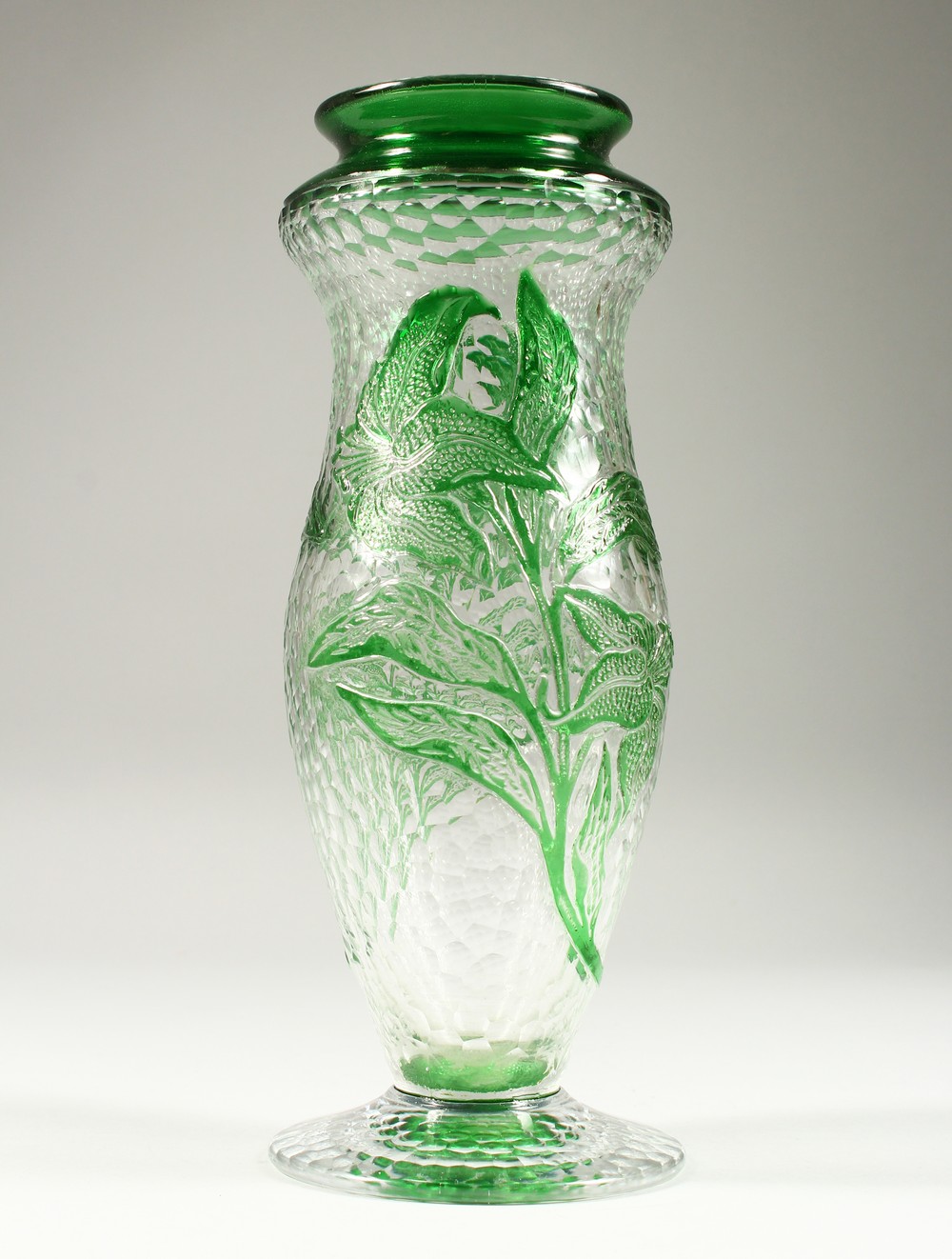 A FRENCH MOULDED AND CUT GLASS PEDESTAL VASE, with green floral decoration. 10.75ins high.