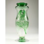 A FRENCH MOULDED AND CUT GLASS PEDESTAL VASE, with green floral decoration. 10.75ins high.