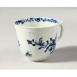 A WORCESTER BLUE AND WHITE HERRINGBONE MOULDED COFFEE CUP, painted with scattered flowers and a most