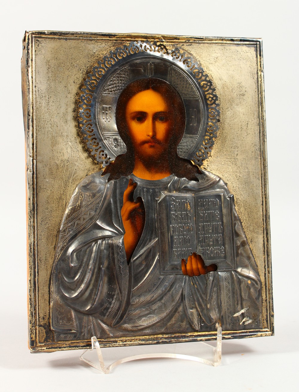 A RUSSIAN ICON, with silver overlay. Maker: C.R. 8.5ins x 6.5ins.