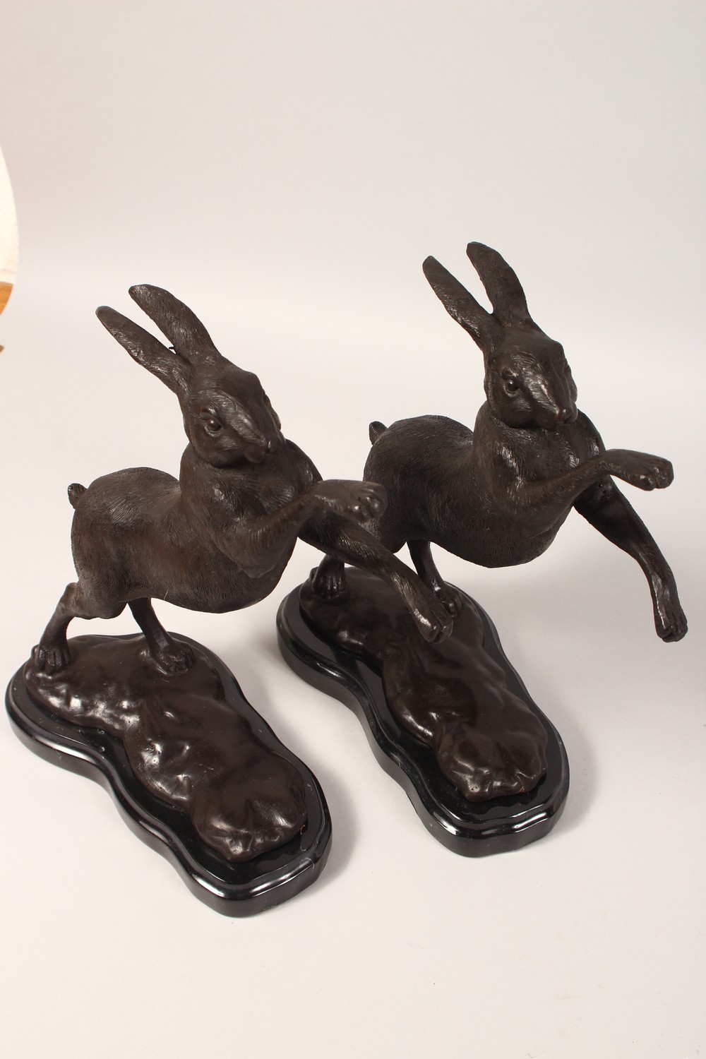 A SMALL PAIR OF BRONZE "BOXING HARES". 12ins high. - Image 2 of 3