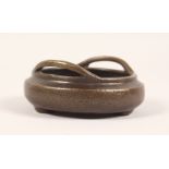 A SMALL BRONZE CIRCULAR TWIN HANDLED CENSER. 4.5ins wide.