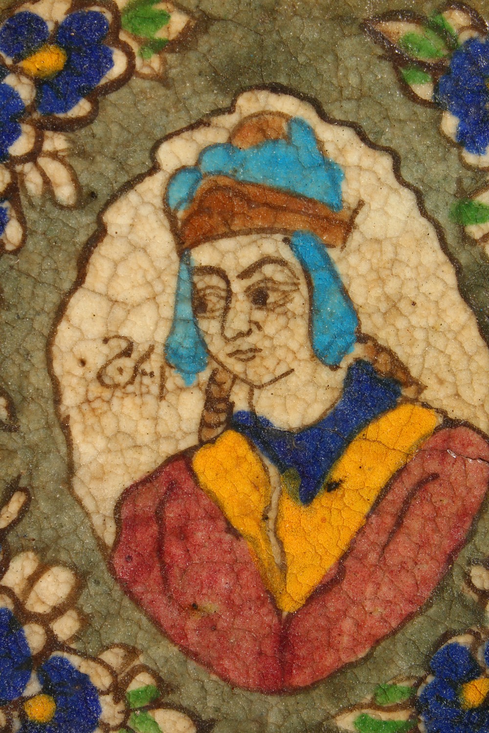 AN ISLAMIC POTTERY TILE, painted with a bust within a floral border, mounted in a later carved - Image 2 of 8