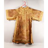 AN UNUSUAL EARLY 20TH CENTURY RUSSIAN COAT, with highly ornate gold thread embroidered decoration,