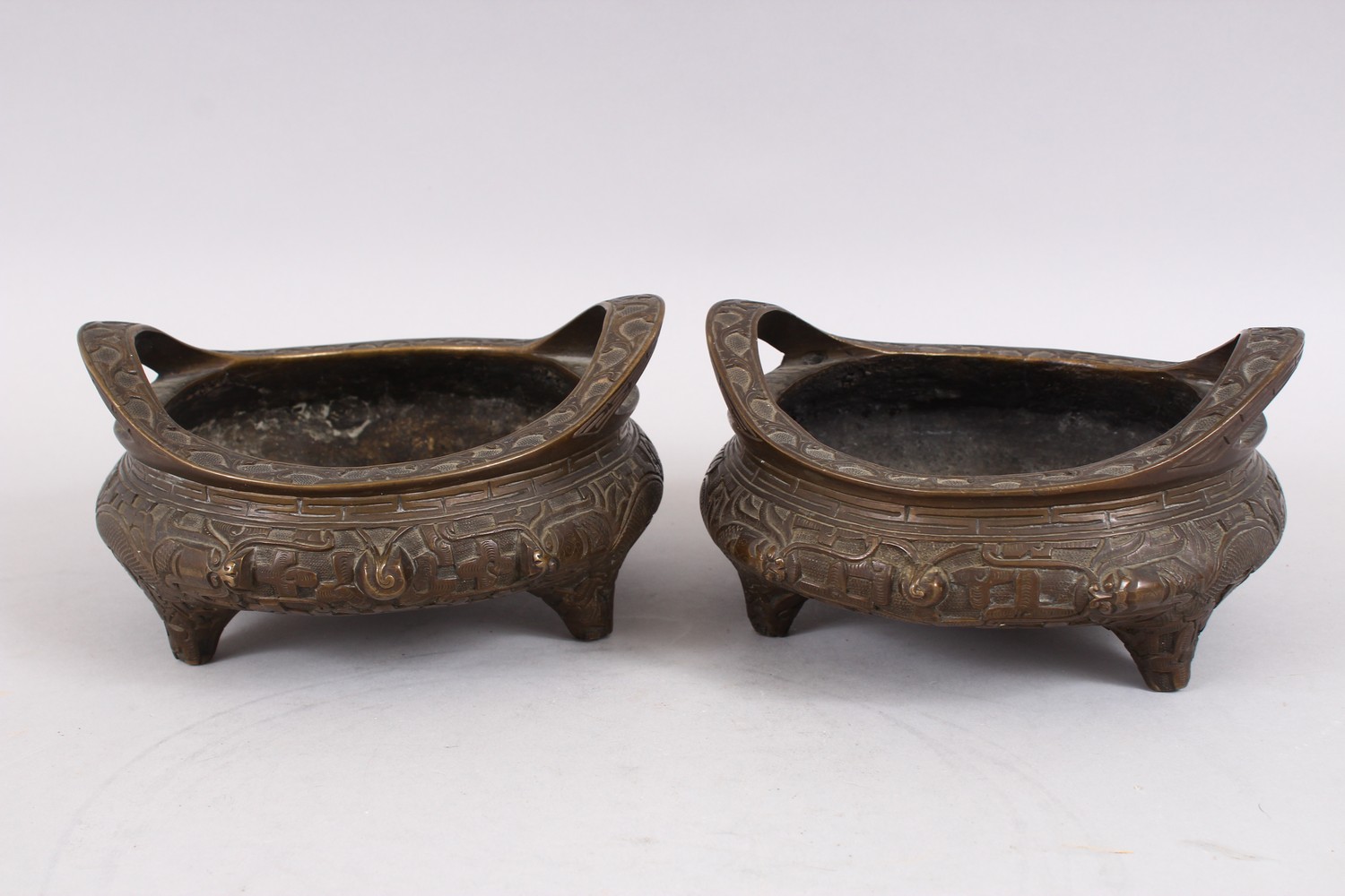 TWO GOOD CHINESE BRONZE TRIPOD CENSERS, Both with deep carved scenes of chilongs and archaic design, - Image 3 of 9