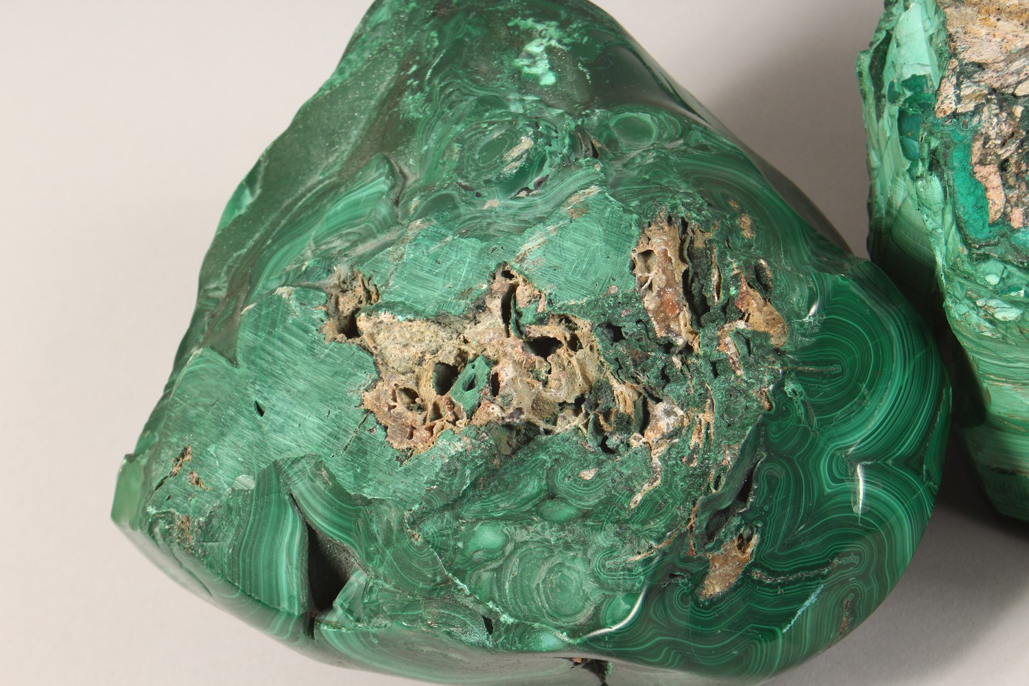 A LARGE NATURALISTIC PIECE OF MALACHITE, partially carved to form a dish, and two similar pieces ( - Image 7 of 9