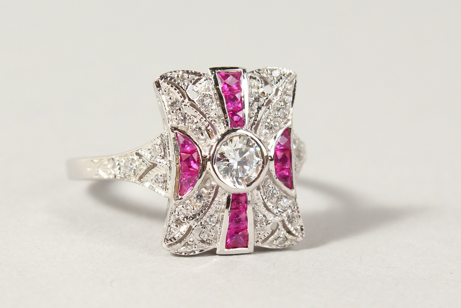 A SILVER ART DECO DESIGN FAUX RUBY AND CZ RING.