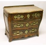 A LOUIS XV STYLE FRENCH OAK SERPENTINE FRONT COMMODE, comprising two short and two long drawers, all