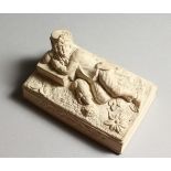 A LATE 19TH CENTURY WHITE MOULDED CLAY PAPERWEIGHT, modelled as a sleeping man. 4.25ins long.