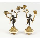 A GOOD PAIR OF 19TH CENTURY FRENCH BRONZE AND ORMOLU TWO-LIGHT CANDLESTICKS, on circular marble