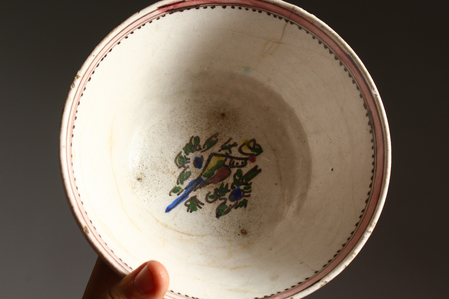 AN EARLY ISLAMIC POTTERY CIRCULAR BOWL, painted with birds. 7.5ins diameter. - Image 5 of 7