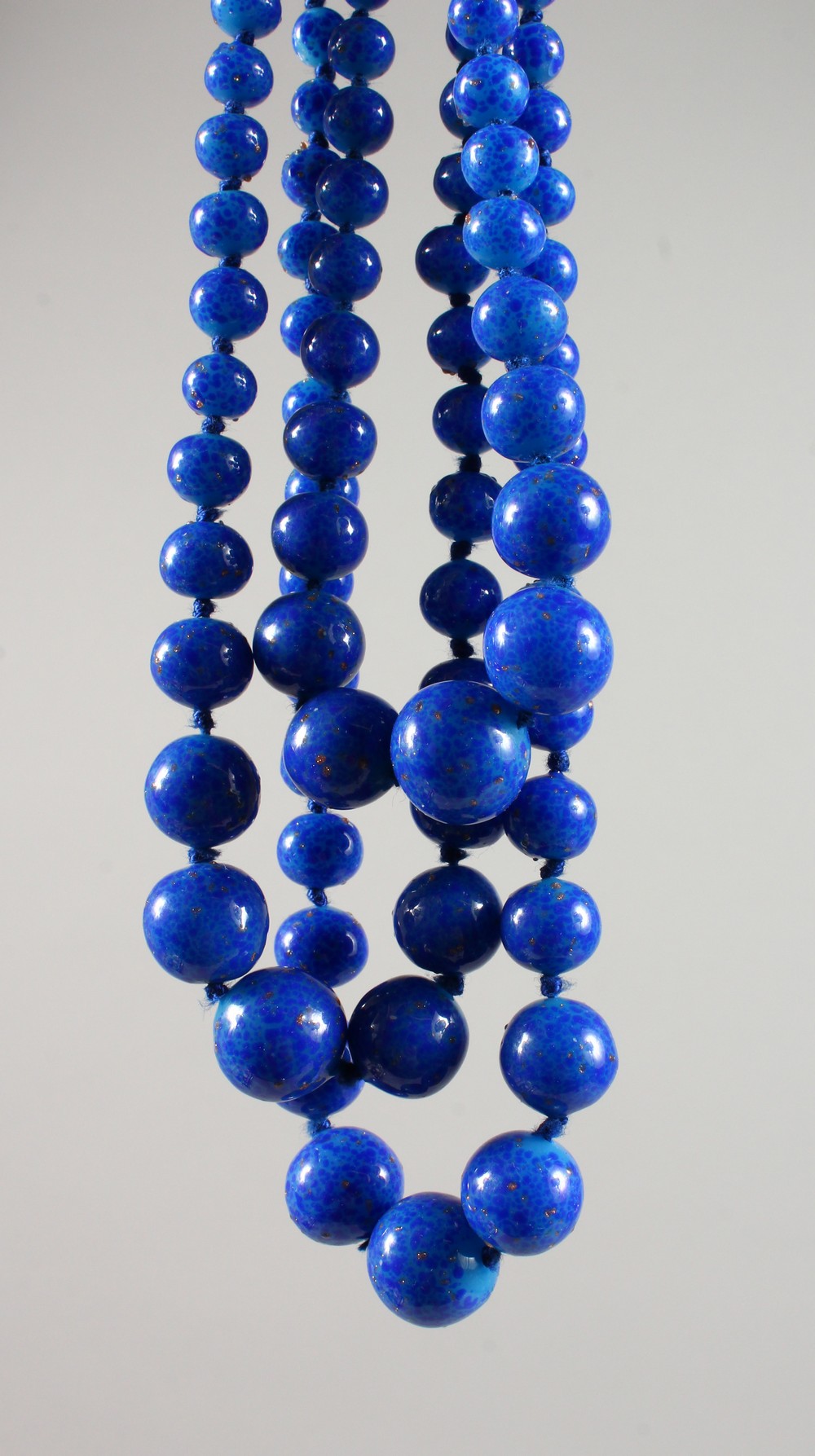 A LAPIS STYLE THREE-ROW NECKLACE.