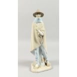 ROYAL COPENHAGEN, A LARGE FIGURE OF A MAN, wearing a broad brimmed hat and cape. 16ins high.