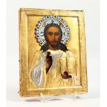 A RUSSIAN ICON, with silver gilt and enamel overlay. Maker: E.V. 8.5ins x 7ins.