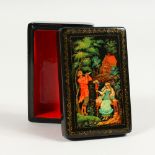 A RUSSIAN BLACK PAPIER MACHE BOX, "Shepherd and Shepherdess", in original cardboard box. 3.5ins x